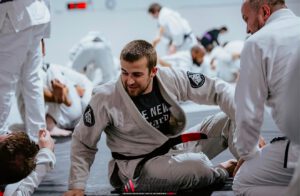 Professor Cody MacCharles coaching adult Brazilian Jiu-Jitsu students during a training session.