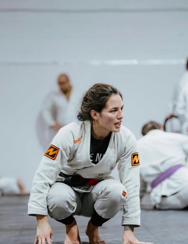 Professor Shiv Barnes wearing a white Brazilian Jiu-Jitsu gi and black belt during training.