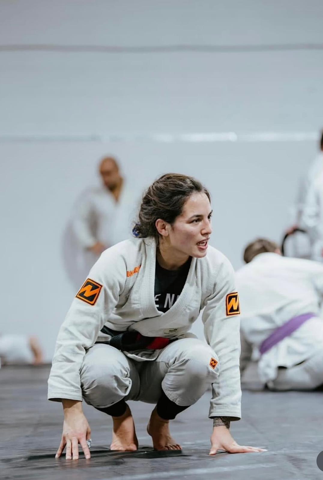 Professor Shiv Barnes wearing a white Brazilian Jiu-Jitsu gi and black belt during training.