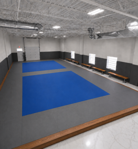 Concept rendering of the True North Martial Arts Newmarket dojo viewed from the southwest, showing the full tatami area and viewing benches.